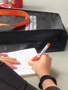 Attendee takes notes during a session.