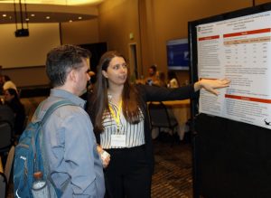 Grad student Luna Pittet Gonzalez talks about her research at a poster session.