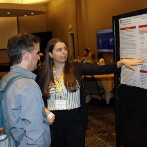 Grad student Luna Pittet Gonzalez talks about her research at a poster session.