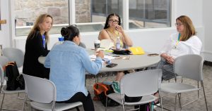 Attendees talk at a session on teaching students about community engaged research.