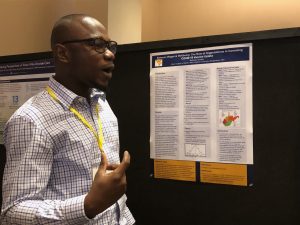 West Virgnia University grad student Nathaniel Godwin speaks about his research at a grad student poster session.