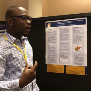 West Virgnia University grad student Nathaniel Godwin speaks about his research at a grad student poster session.