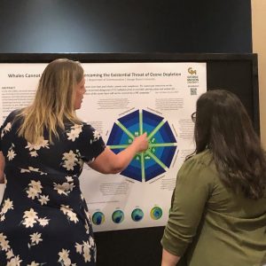 George Mason University grad student Maggie Wise explains her research during a poster session.